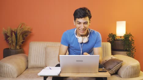 Man-looking-at-laptop-applauding.