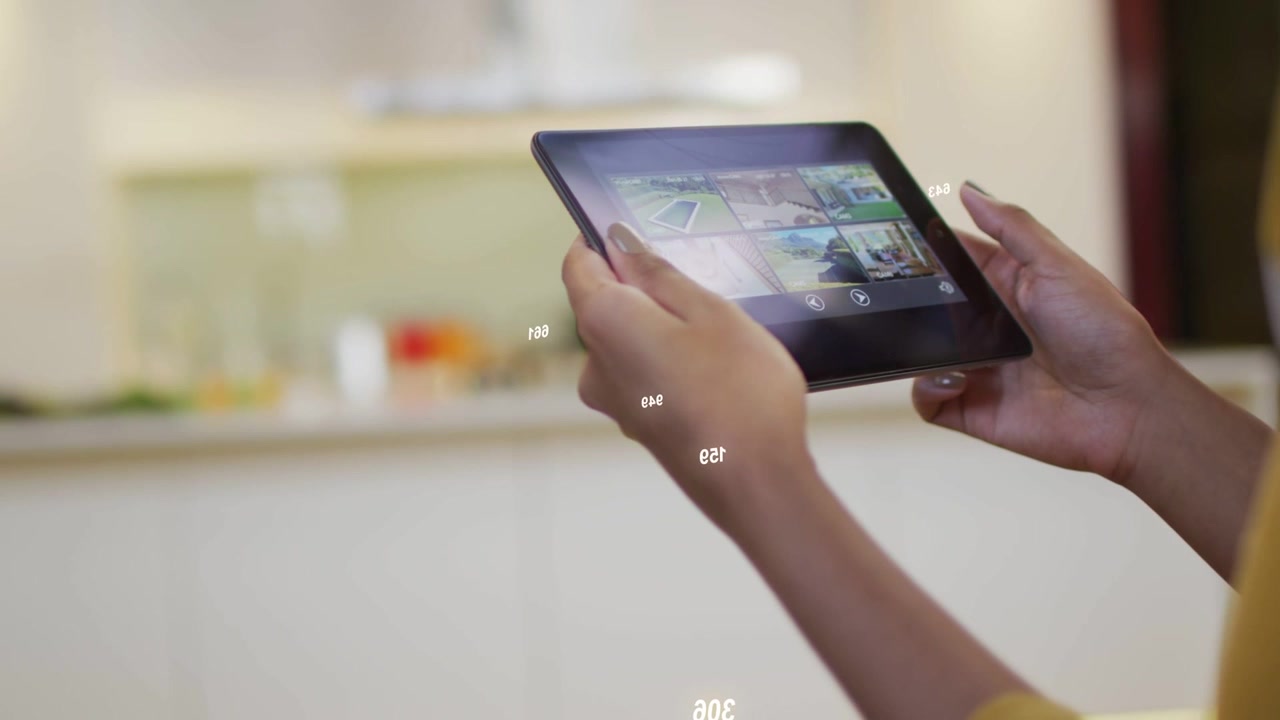 Woman tapping tablet thumbs in kitchen, causing numeric overlay while selecting pictures for design