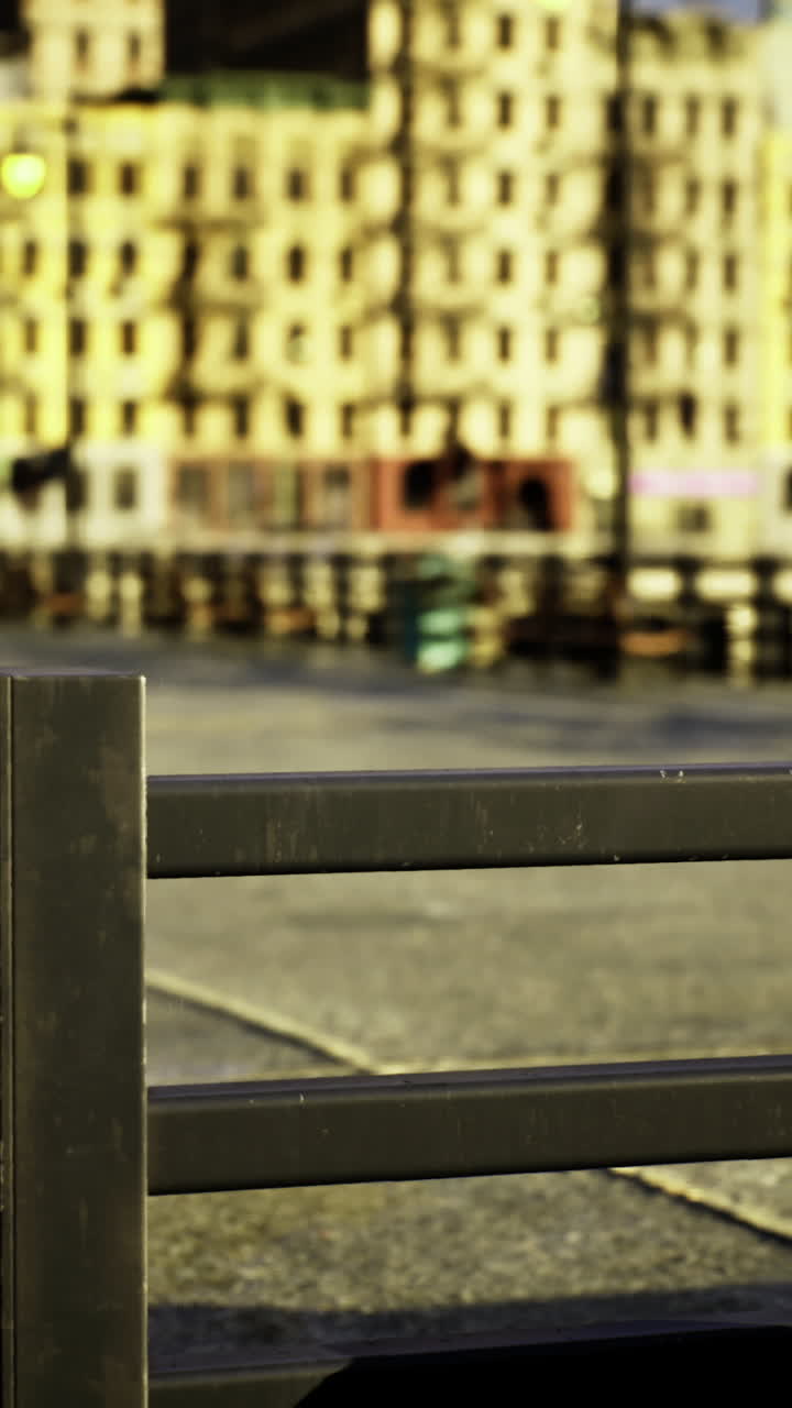 Colorful buildings overlook a waterfront promenade during sunny daytime