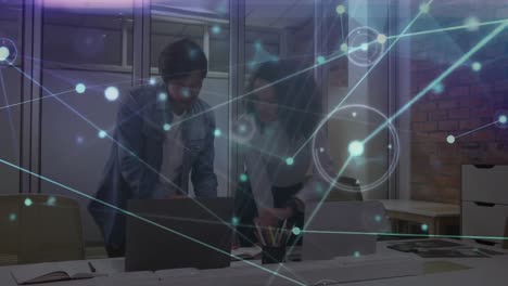 Animation-of-network-of-connections-over-diverse-man-and-woman-shaking-hands-at-office