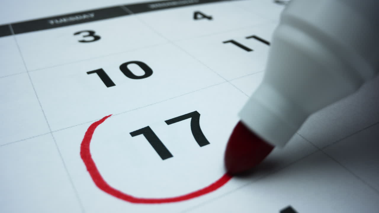 Business calendar for event planning. Female hand marking date on calendar