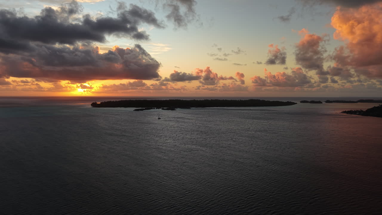 Bora Bora Island, French Polynesia. Aerial View of Sunset and Clouds Above Lagoon and South Pacific Ocean