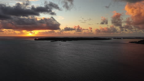 bora bora island, french polynesia. aerial view of sunset and clouds above lagoon and south pacific ocean