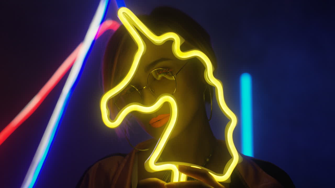 cerca de una mujer con el pelo rubio corto y maquillaje naranja con gafas