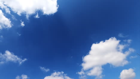 light white clouds floating quickly in the bright blue skies. fluffy clouds reflecting the rays of summer sun.