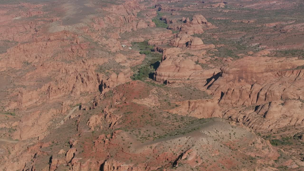 Aerial view of red rock canyon in Moab, Utah under clear skies