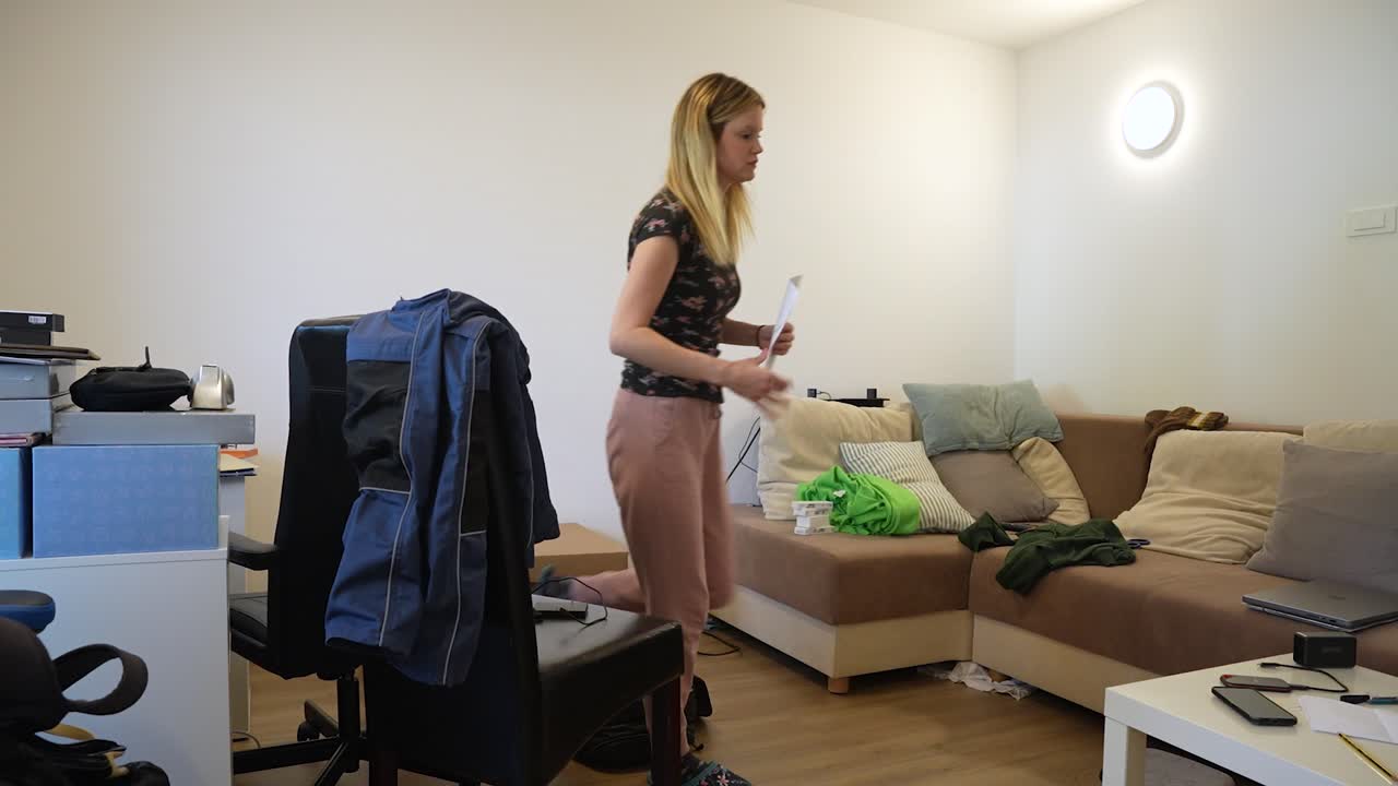 Young couple tiding up the apartment. Timelapse