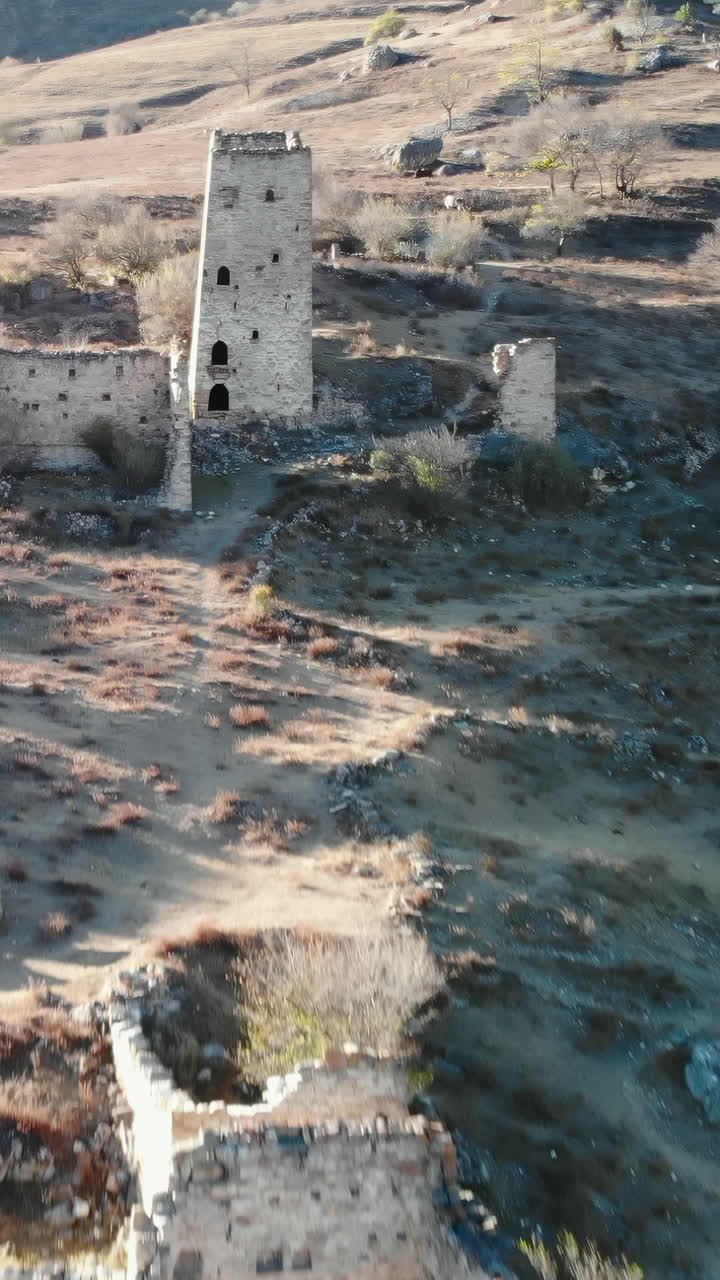 Vista aerea di antiche torri di pietra e rovine su un fianco di montagna