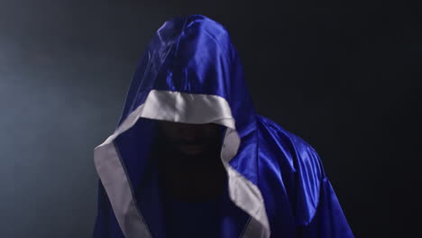 boxer in a hooded robe, ready to fight