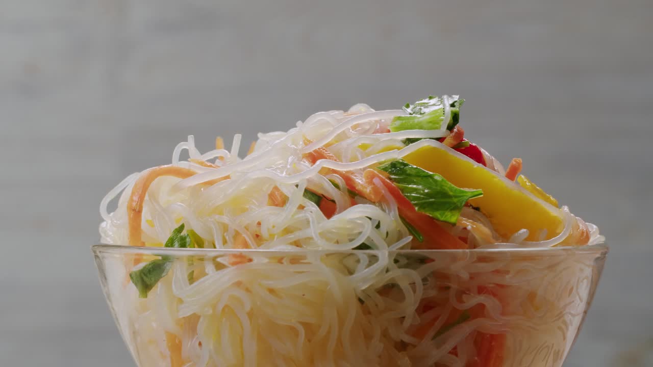 Glass noodles salad with meat and carrots fermented close up asian chinese traditional food.