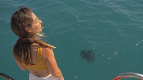 pretty tourist lady watching a manta ray from the surface -queensland, australia -midshot