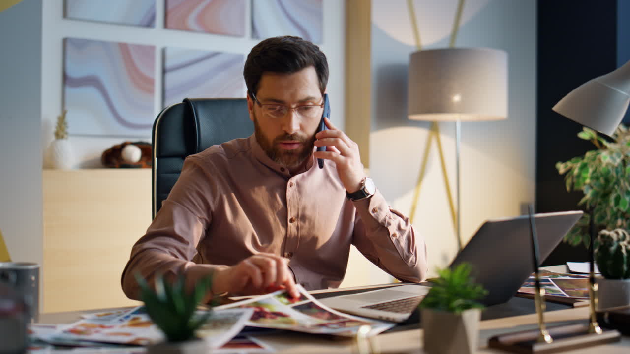 Business man speaking smartphone at workplace. Entrepreneur calling phone office