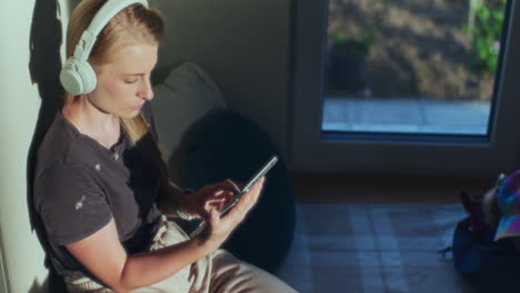 a woman uses a digital tablet and is lost in thought