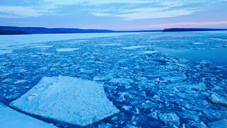 aerial video capturing the expanse of colossal ice formations drifting in the water