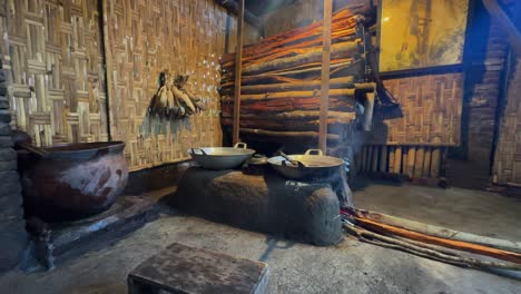 traditional indonesian cooking room with furnace and pile of firewood