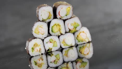 Stack-of-maki-sushi-on-black-background