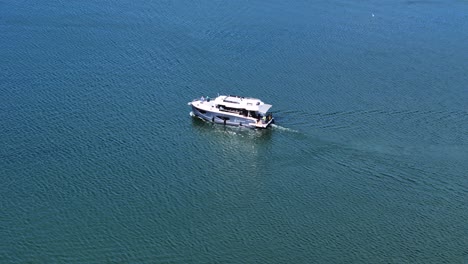 New modern luxury yacht in lake, aerial orbit view