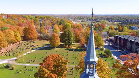 historic church steeple, cemetery surrounded by vivid fall trees, estrie, québec