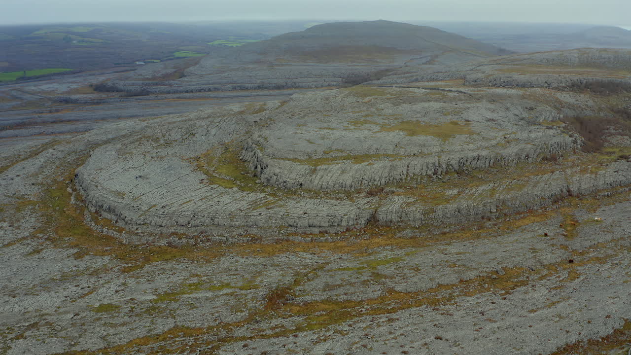Smooth aerial shot of the Burren mountain summits in slow motion, showcasing their rugged beauty