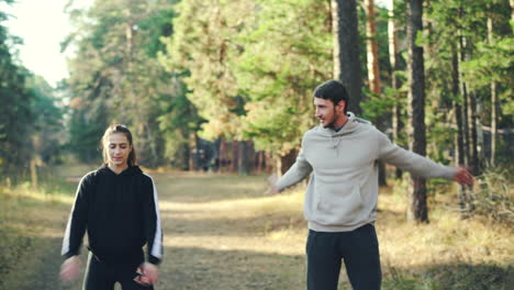 couple exercising in the forest