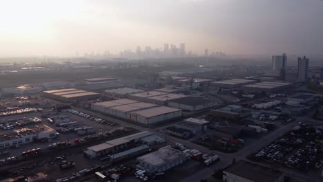 aerial drone shot of downtown calgary covered in wildfire smoke