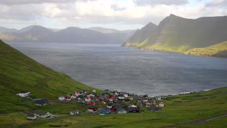 Paradise-view-of-Funningur-Village-with-sun-illuminating-mountains-and-ocean