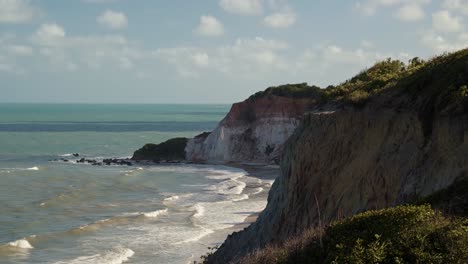 tilt up shot revealing the beautiful coastal clay cliffs near the lookout point of gramame beach near the coastal beach capital city of joao pessoa in paraiba, brazil on a warm summer day