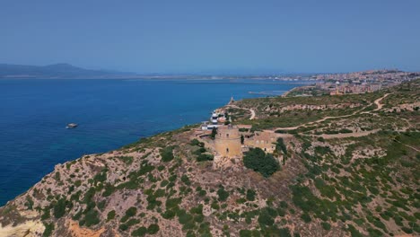 Historic-Calamosca-Tower-located-in-Cagliari-and-facing-blue-ocean-water