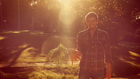 Happy-handsome-man-holding-carrot