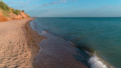 man singing into microphone on beach. aerial view of man singing to microphone on beach
