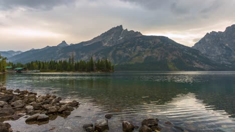 teton mountain range reflects on jenny lakes crystal clear water in wyoming