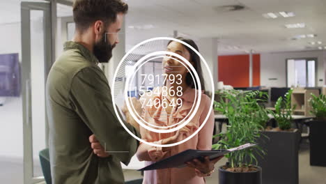 coworkers discussing business data with hud overlay while using tablet and clipboard in office