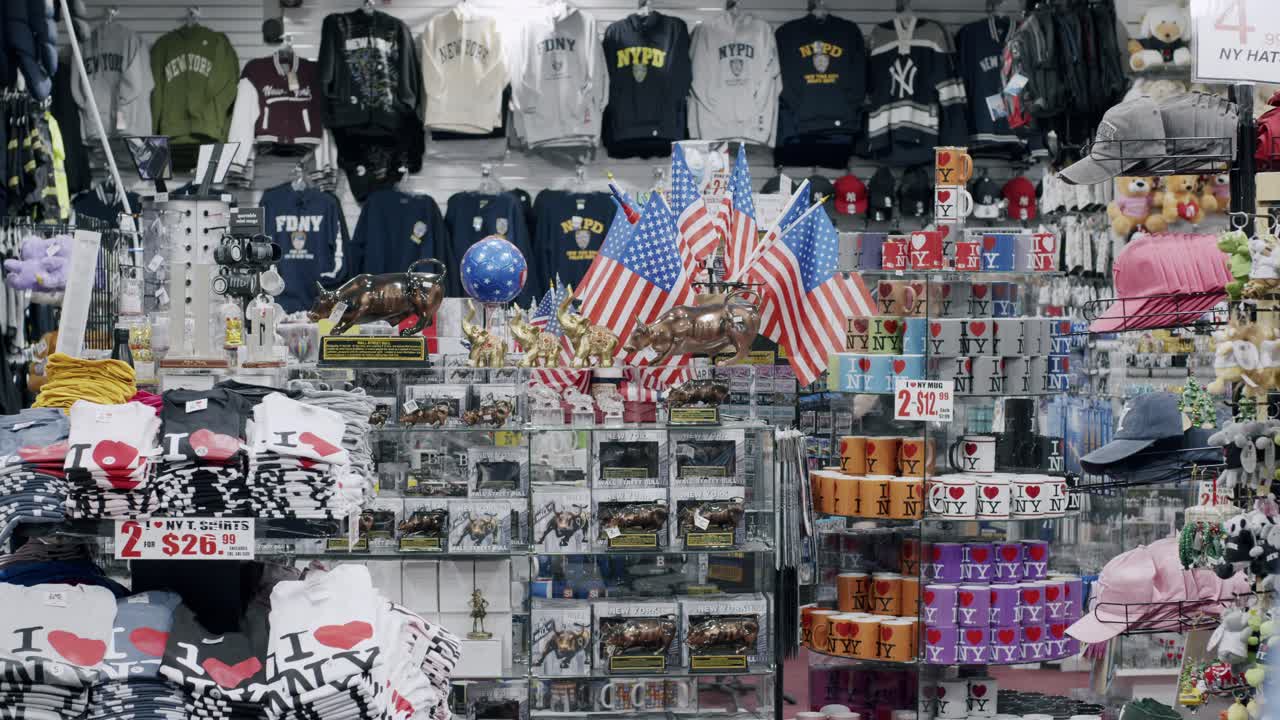 A souvenir shop in New York City filled with apparel, mugs, and American flags on display