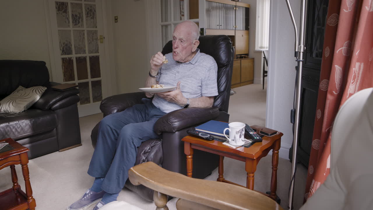 Senior man eating indoors