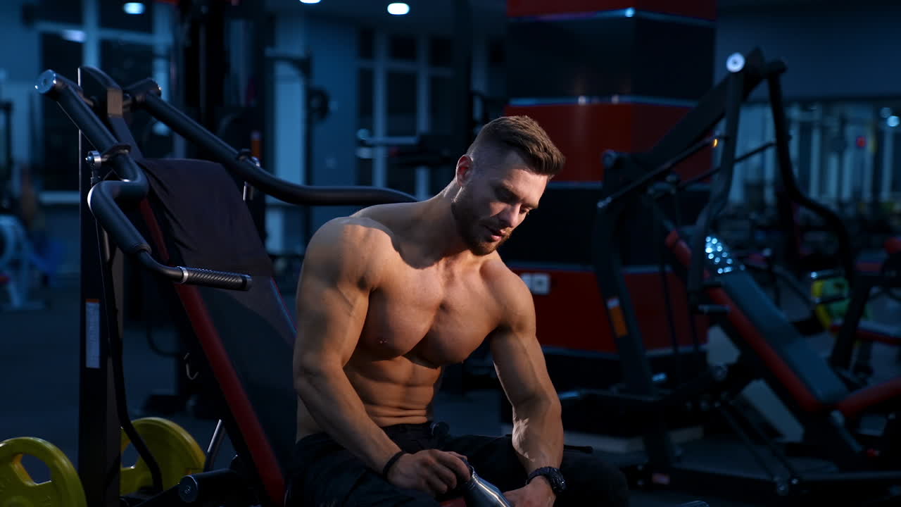 Athletic body. Shirtless model guy is posing to the camera. Strong muscular man with perfect body.