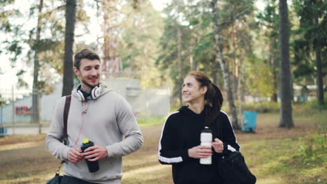 couple high-fiving and walking in a park