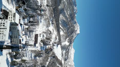 Pullback-aerial-view-of-Mount-Myoko,-Akakura,-portrait-video