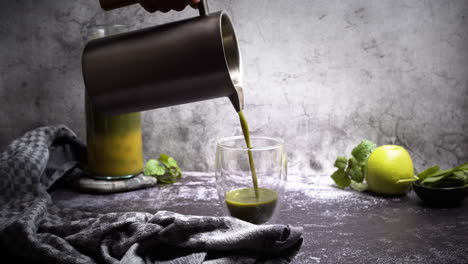 Pouring-blended-green-smoothie-in-glas