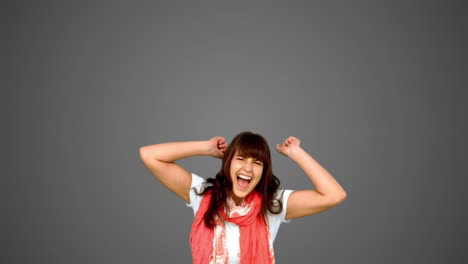 brunette woman jumping on grey background