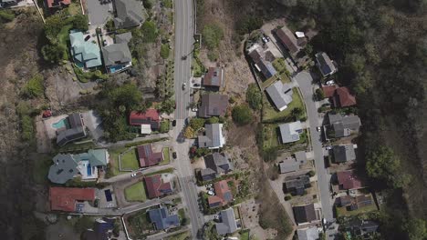 Overhead-view-of-car-driving-along-secluded-road-tracking-forward