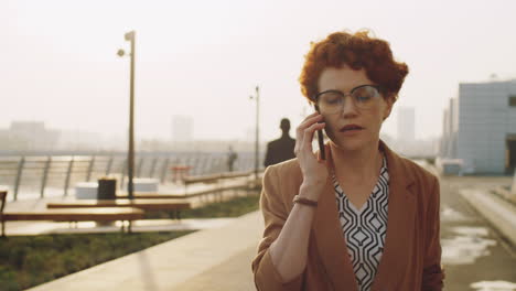 Businesswoman-Walking-on-Street-and-Having-Phone-Talk