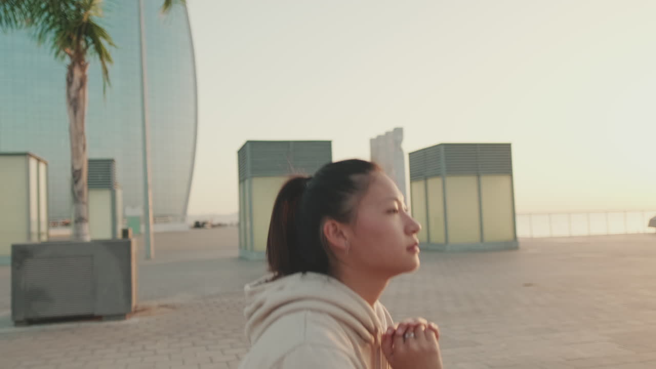 Asian woman jogging in the city