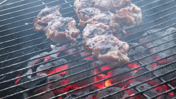 Chicken Thigh Fillets grilling on a Charcoal BBQ