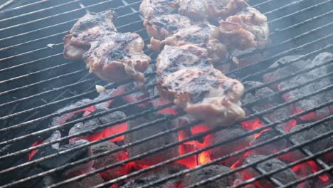 chicken thigh fillets grilling on a charcoal bbq