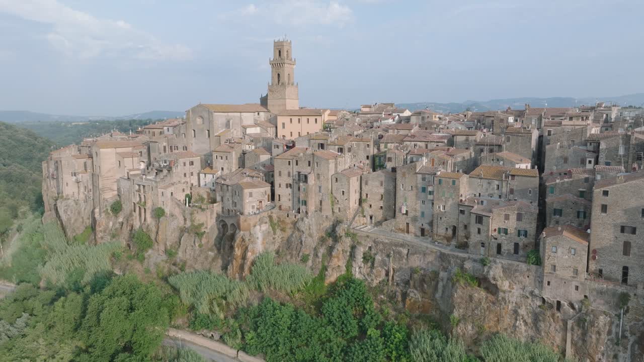 High Altitude Aerial Drone view of the hilltop Medieval town of Pitigliano, Tuscany in morning light, with the Valdorcia and old buildings, in 4K