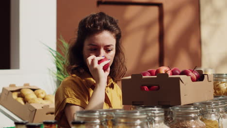 woman smelling locally grown apples