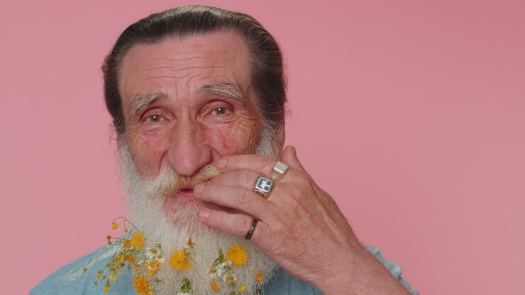 Cheerful lovely flowered beard senior grandfather fashion model smiling and looking at camera alone