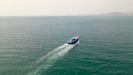 fishing boat cruising in the ocean to catch fish in phu quoc island, vietnam. - aerial shot