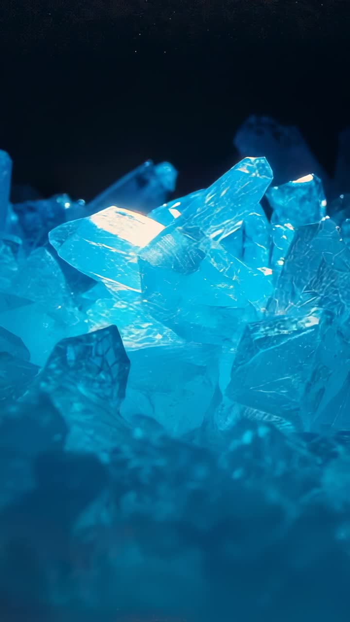 Vertical video: Shifting camera revealing crystal facets in blue cluster on platform under LED glow
