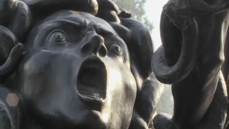 a statue of medusa seems to be crying out in horror